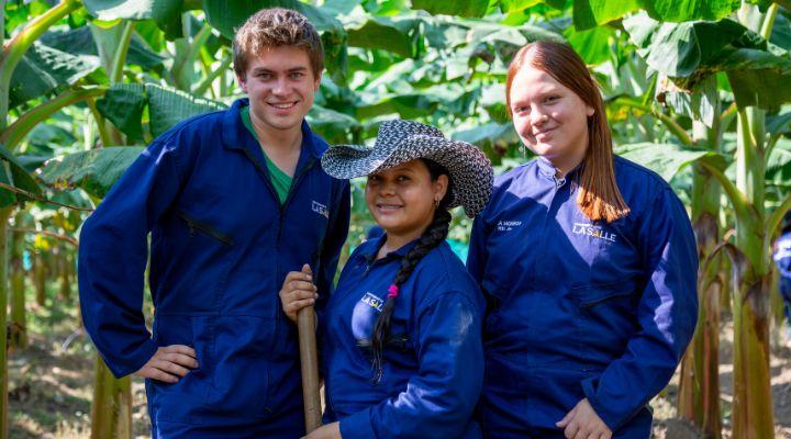 Jóvenes utopienses en medio de los cultivos